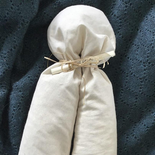 soft white cylindrical ache sack, tied up with string